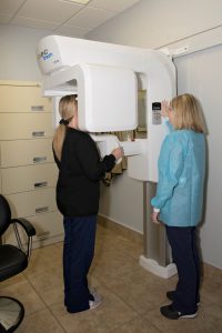 A patient comfortably standing in our Cone beam computed tomography (CBCT) Machine